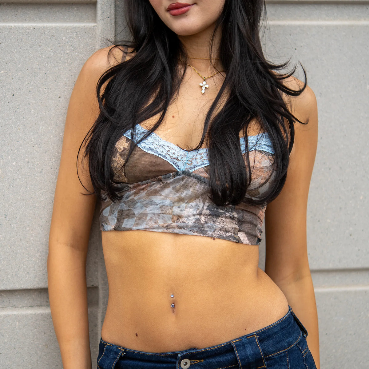 Lab Sapphire Martini 0.8 ct navel ring worn with a printed mesh crop top and jeans
